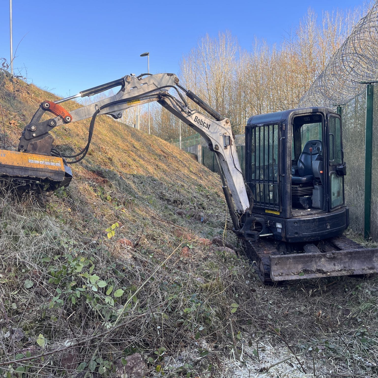 site clearance digger removing vegetation